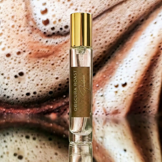 Eausodramatic obscura roast perfume bottle with golden cap, minimal glass bottle on espresso coffee foam aesthetic background